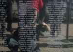 memorial wall with names etched into face of wall